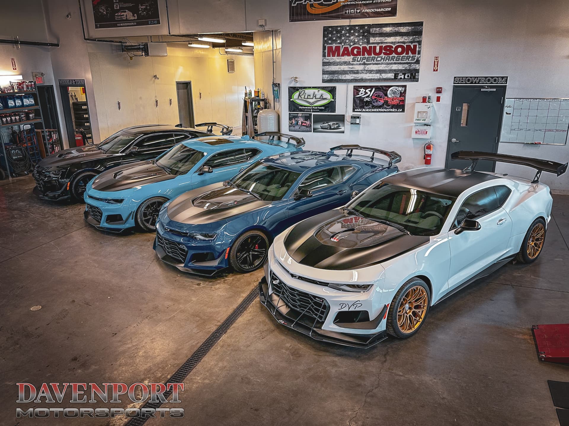 Four sixth-generation Camaro performance builds parked inside the Davenport Motorsports shop in Calgary